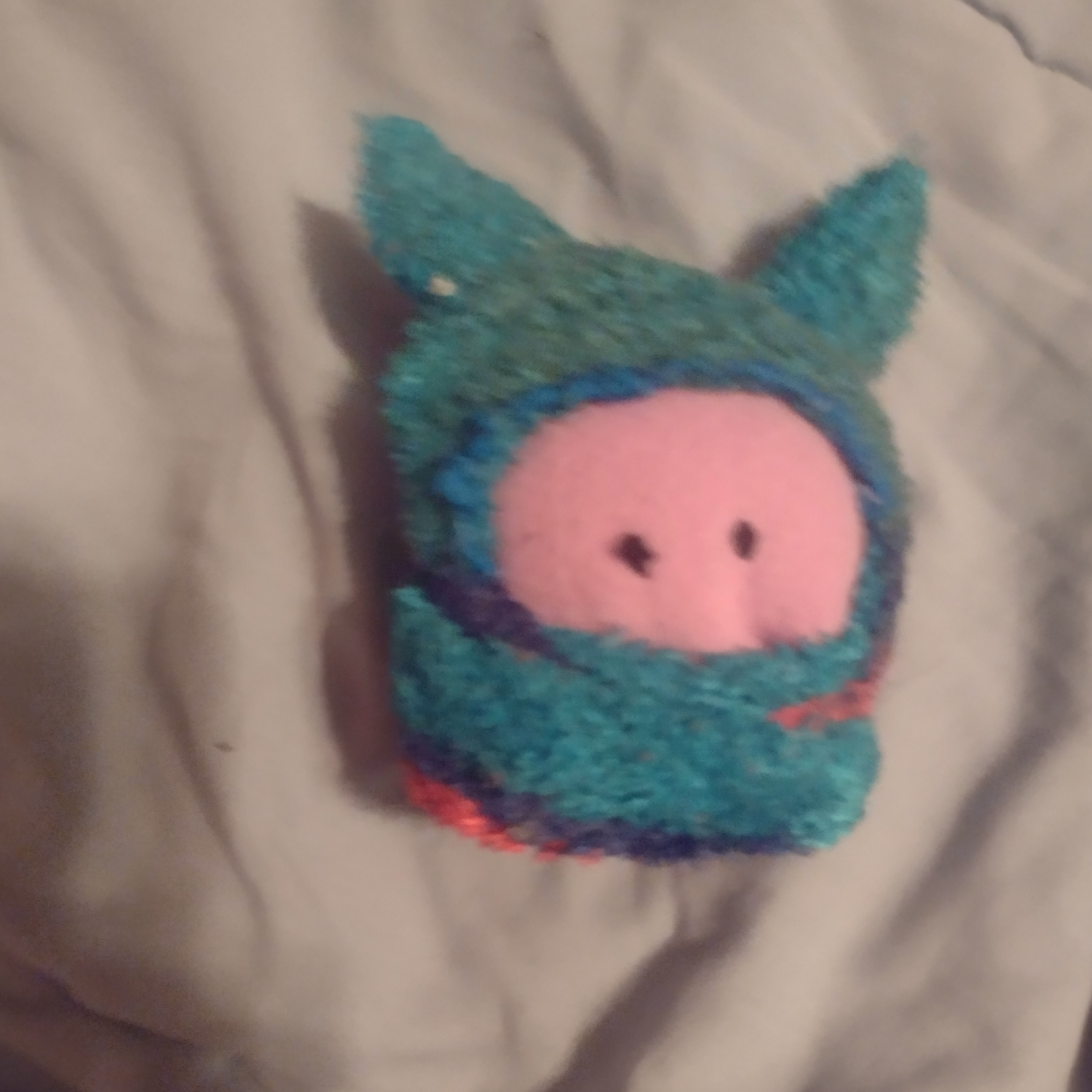 a silly plushy with a blue hoodie